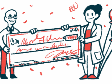 A researcher accepts a giant check as balloons and confetti surround them.